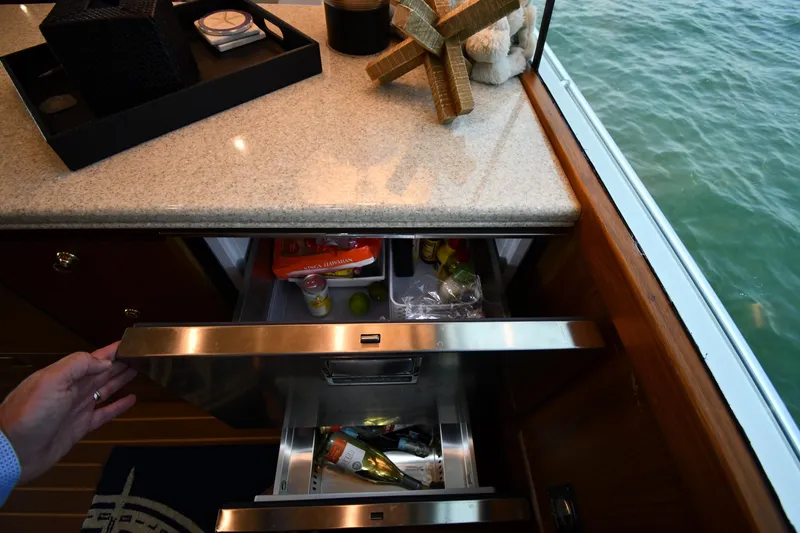 Slide: The Image of Luxury yacht kitchen with open drawer, Ocean Yachts 53 Super Sport, 1996 model, near water. - 49