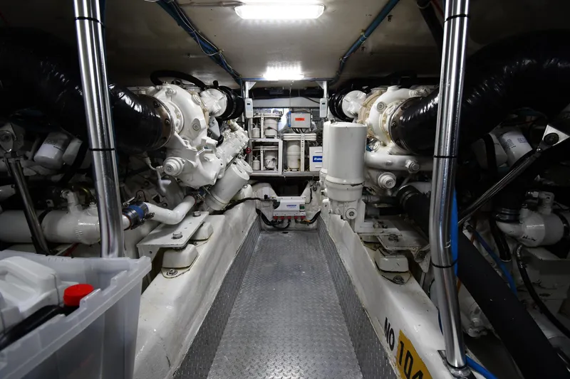 Slide: The Image of Engine room of 1996 Ocean Yachts 53 Super Sport, showcasing dual engines and mechanical components. - 60
