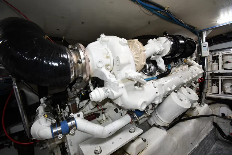 Slide: The Image of Engine room of 1996 Ocean Yachts 53 Super Sport, showcasing powerful marine engine components. - 62