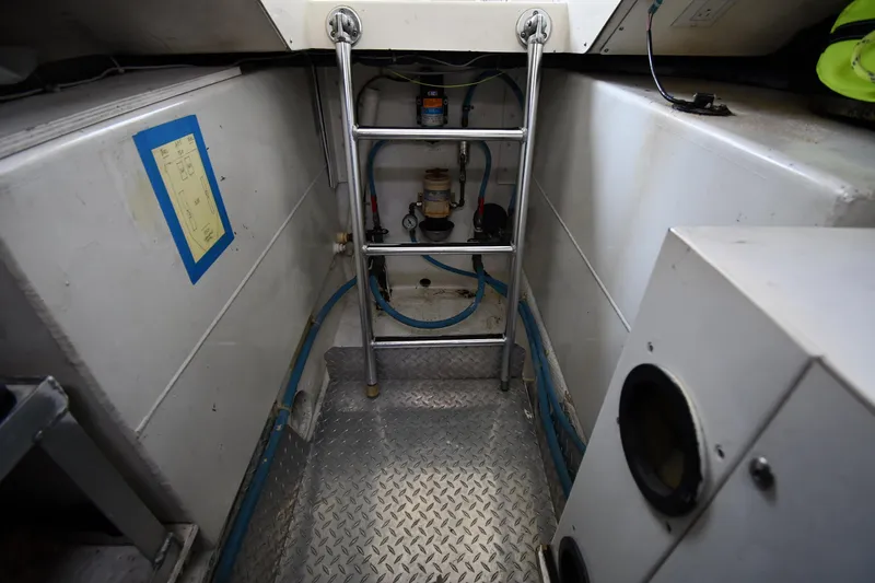 Slide: The Image of Engine room of 1996 Ocean Yachts 53 Super Sport with ladder and equipment. - 73