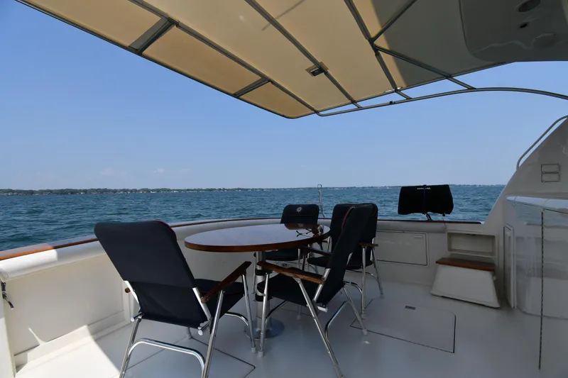 Slide: The Image of Outdoor seating on 1996 Ocean Yachts 53 Super Sport, overlooking serene ocean view. - 8