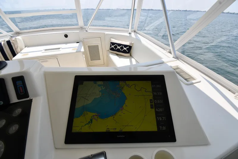 Slide: The Image of Cockpit view of 1996 Ocean Yachts 53 Super Sport with navigation display and ocean backdrop. - 14
