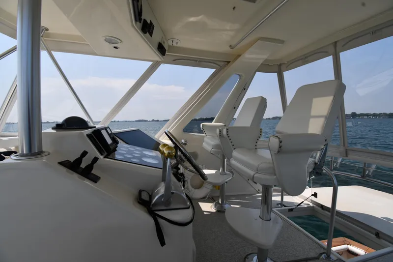 Slide: The Image of Interior view of 1996 Ocean Yachts 53 Super Sport cockpit with white seating and control panel. - 17