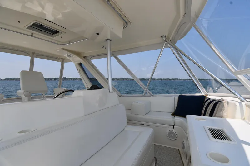 Slide: The Image of Interior view of 1996 Ocean Yachts 53 Super Sport, featuring spacious seating and ocean backdrop. - 21