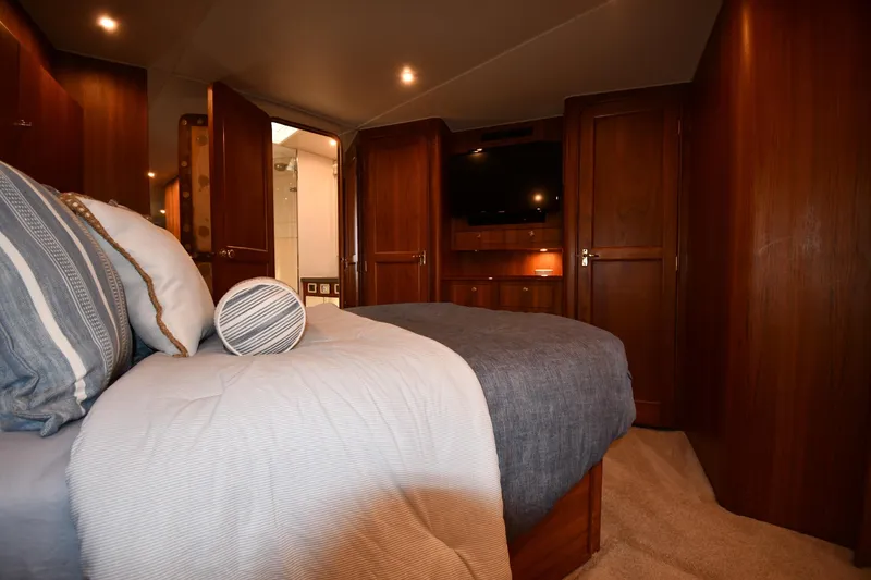 Slide: The Image of Luxurious bedroom interior of 1996 Ocean Yachts 53 Super Sport, featuring elegant wood finishes. - 26