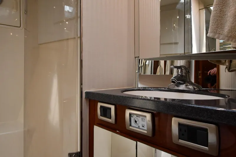 Slide: The Image of Bathroom interior of 1996 Ocean Yachts 53 Super Sport, featuring sink and mirror. - 30