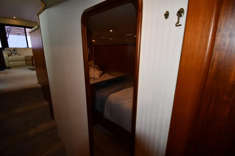 Slide: The Image of Interior of 1996 Ocean Yachts 53 Super Sport, featuring cozy cabin and elegant wood finishes. - 34