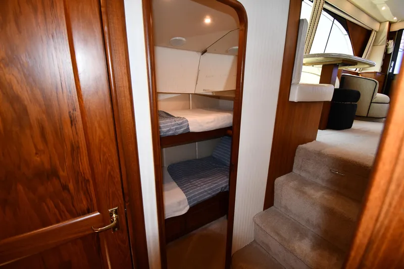Slide: The Image of Interior of 1996 Ocean Yachts 53 Super Sport with bunk beds and carpeted stairs. - 39
