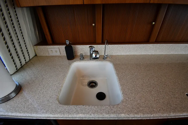 Slide: The Image of Kitchen sink area on a 1996 Ocean Yachts 53 Super Sport boat. - 45