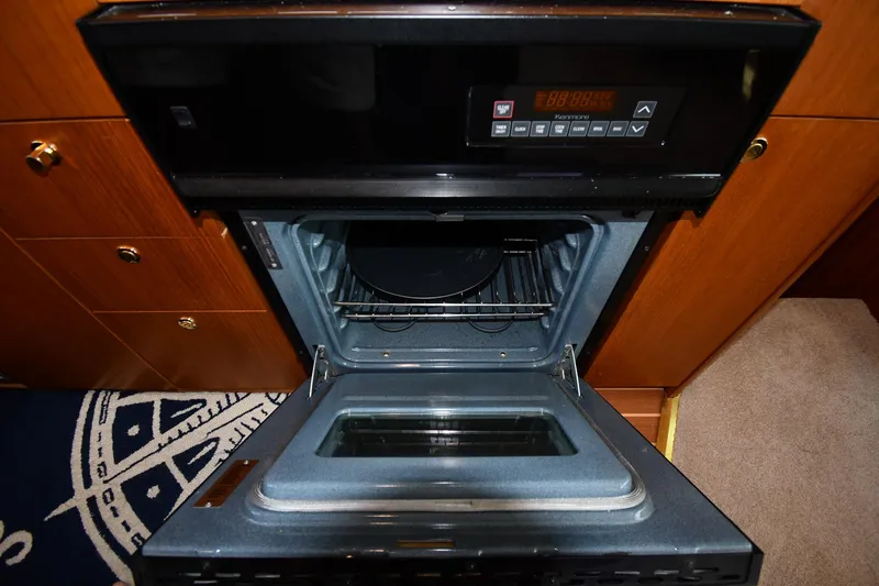 Slide: The Image of Open oven in 1996 Ocean Yachts 53 Super Sport, showcasing interior and control panel. - 47