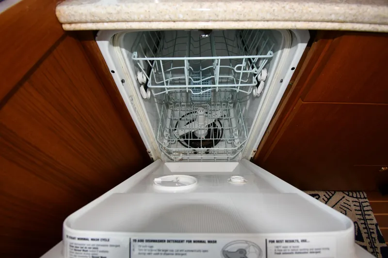 Slide: The Image of Dishwasher inside 1996 Ocean Yachts 53 Super Sport, open with visible racks. - 48