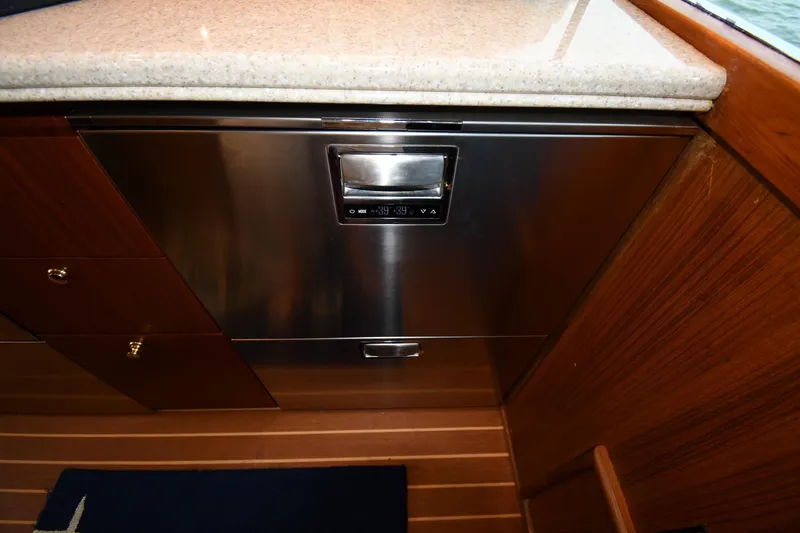 Slide: The Image of 1996 Ocean Yachts 53 Super Sport galley with stainless steel appliance and wooden cabinetry. - 50