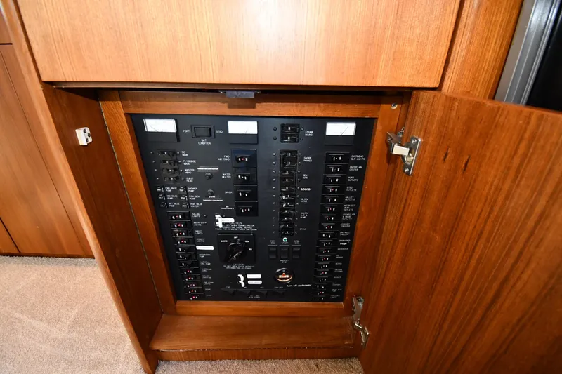 Slide: The Image of Electrical panel inside 1996 Ocean Yachts 53 Super Sport, featuring various switches and controls. - 56