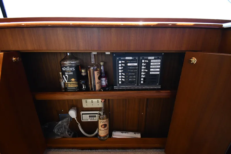 Slide: The Image of 1996 Ocean Yachts 53 Super Sport interior cabinet with liquor bottles and control panel. - 57