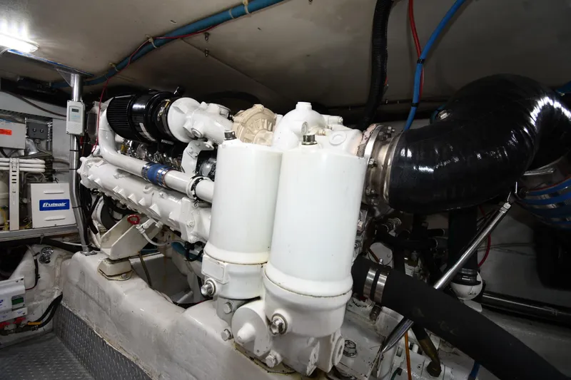 Slide: The Image of Engine room of 1996 Ocean Yachts 53 Super Sport, showcasing marine engine components. - 61