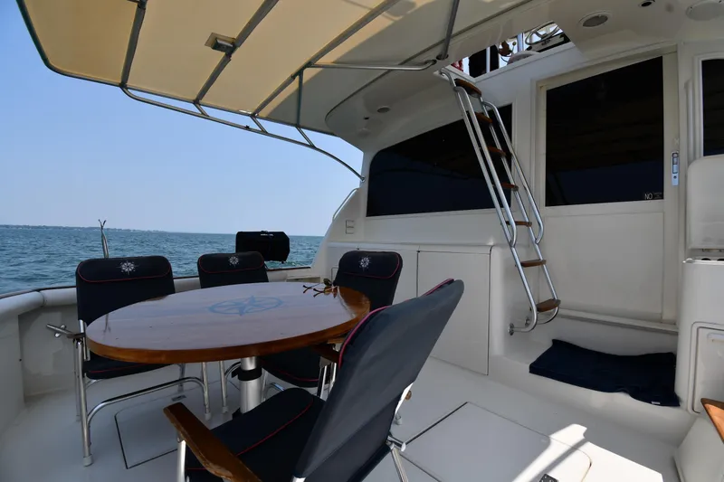 Slide: The Image of Outdoor seating area on a 1996 Ocean Yachts 53 Super Sport, overlooking the ocean. - 7