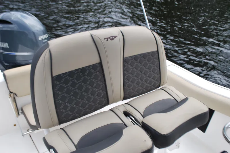 Slide: The Image of 2021 Tidewater 210 CC Adventure boat seating with Yamaha engine on water. - 11