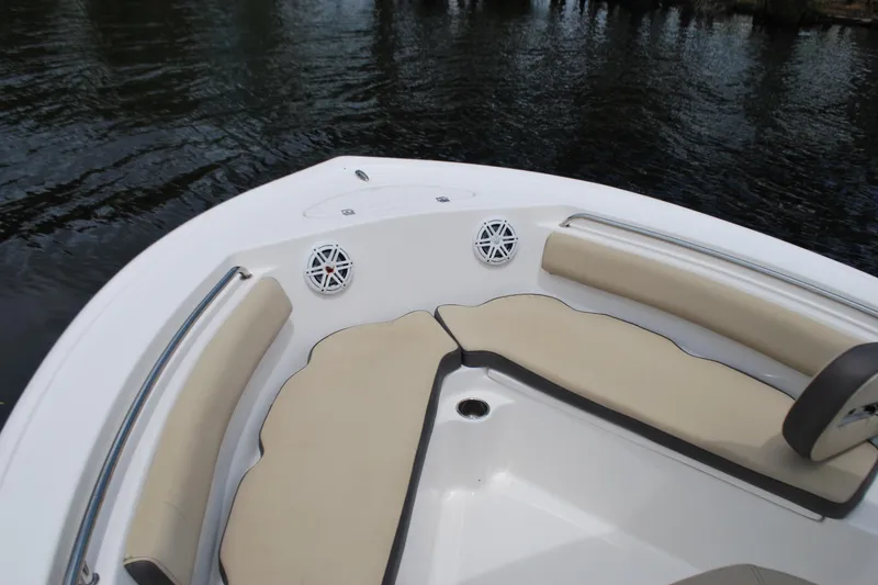 Slide: The Image of 2021 Tidewater 210 CC Adventure boat interior with cushioned seating and speakers. - 3