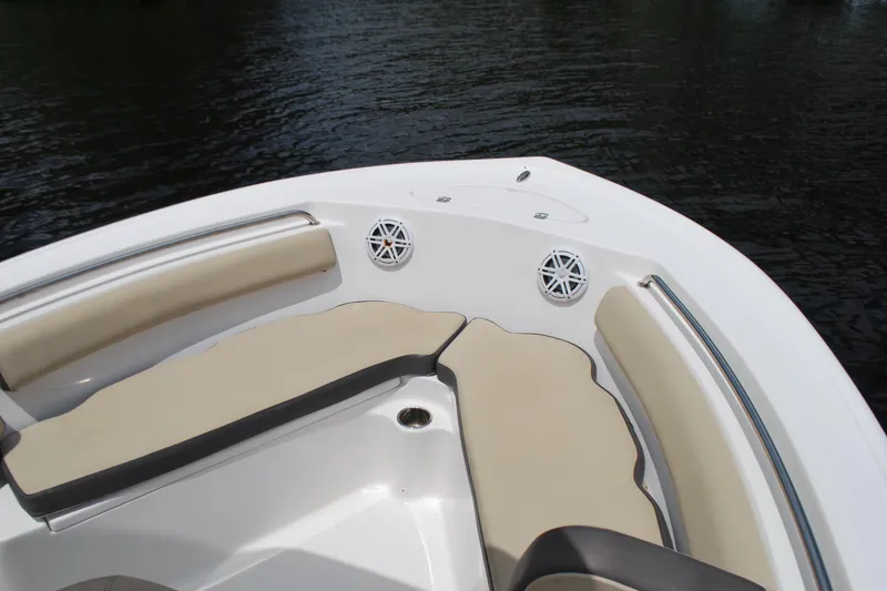 Slide: The Image of 2021 Tidewater 210 CC Adventure boat interior with cushioned seating and speakers. - 4