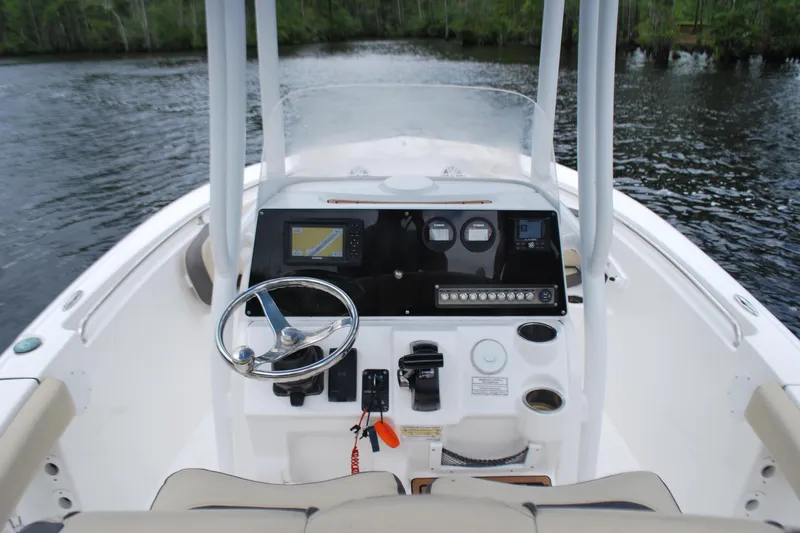 Slide: The Image of 2021 Tidewater 210 CC Adventure boat dashboard with steering wheel and navigation system. - 8