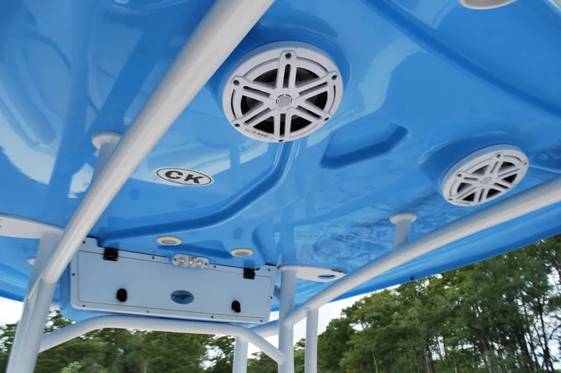 Slide: The Image of 2021 Tidewater 210 CC Adventure boat with blue T-top and integrated speakers. - 9