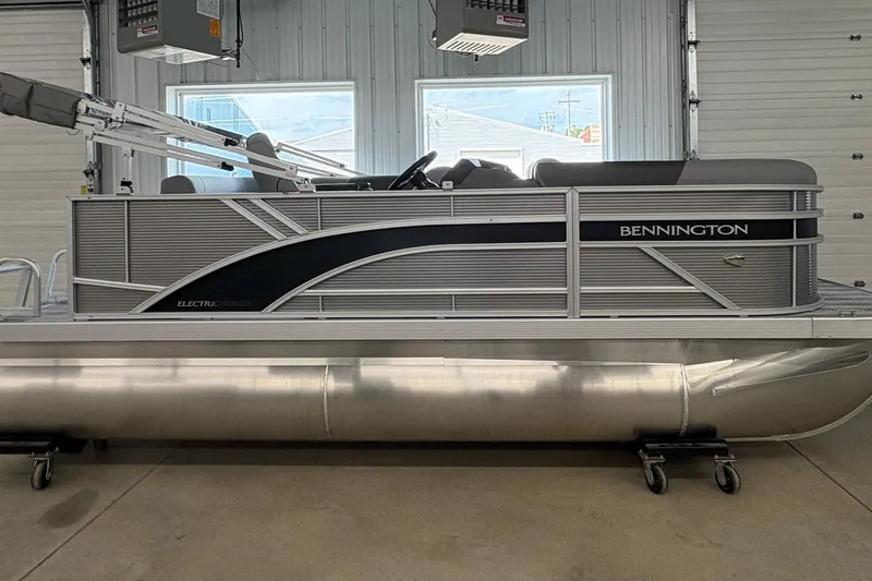 The Image of 2026 Bennington 168 SL Electric pontoon boat in a garage setting. - 0