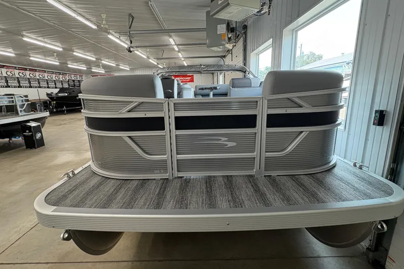 Slide: The Image of 2026 Bennington 168 SL Electric pontoon boat in showroom, showcasing sleek design and modern features. - 2