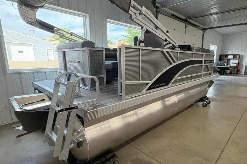Slide: The Image of 2026 Bennington 168 SL Electric pontoon boat in a garage setting. - 3