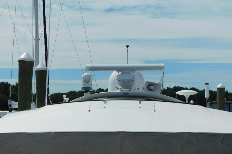 Slide: The Image of 2013 Sea Ray 510 Sundancer yacht docked, featuring radar and navigation equipment. - 11