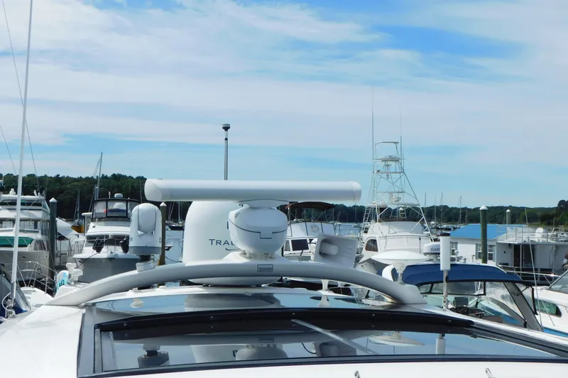 Slide: The Image of 2013 Sea Ray 510 Sundancer yacht docked at a marina under a clear blue sky. - 13