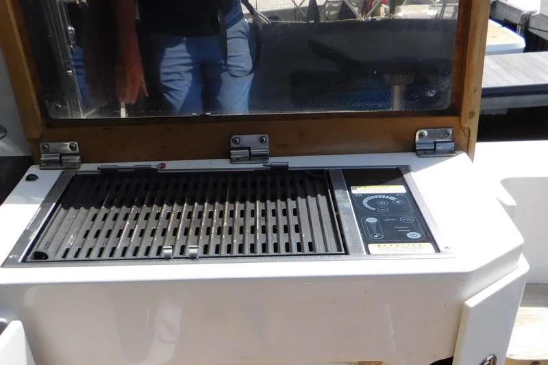 Slide: The Image of Outdoor grill on 2013 Sea Ray 510 Sundancer yacht, featuring control panel and protective cover. - 18