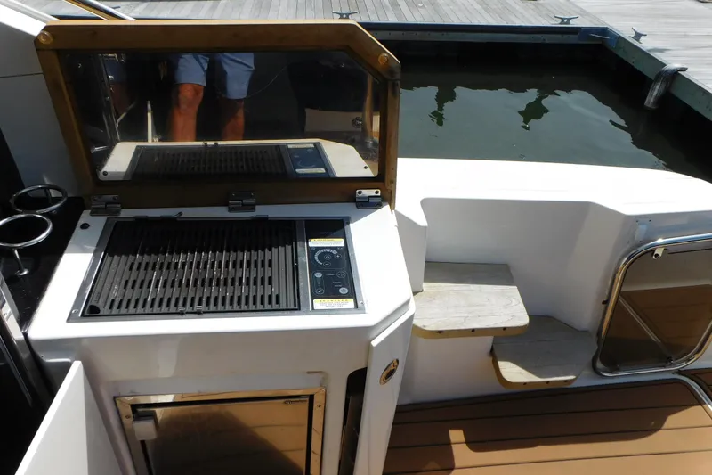 Slide: The Image of Outdoor grill on 2013 Sea Ray 510 Sundancer yacht deck near water. - 19