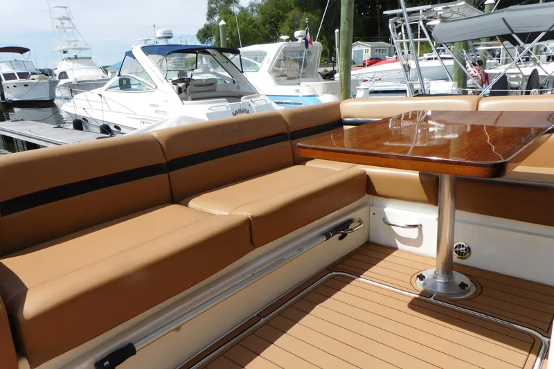 Slide: The Image of Luxurious seating area on a 2013 Sea Ray 510 Sundancer yacht, docked at a marina. - 23