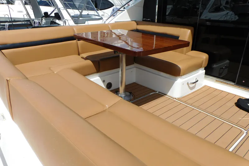 Slide: The Image of Luxurious seating area on 2013 Sea Ray 510 Sundancer yacht with wooden table. - 24
