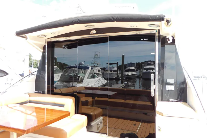 Slide: The Image of 2013 Sea Ray 510 Sundancer yacht with sleek glass doors and luxurious seating area. - 25