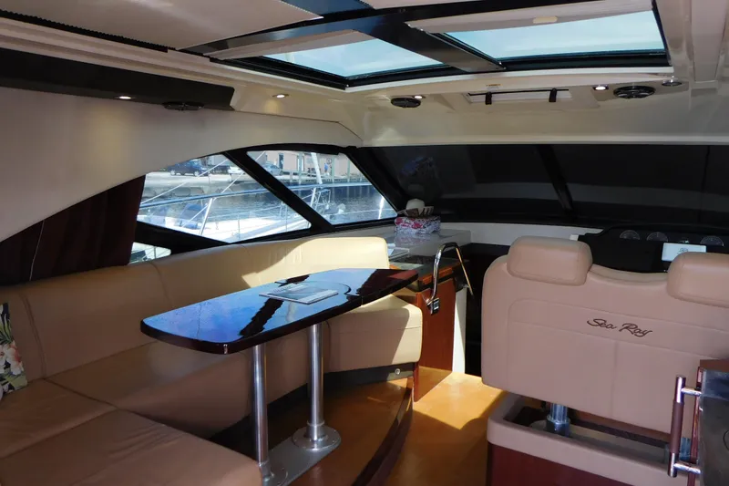 Slide: The Image of Luxurious interior of 2013 Sea Ray 510 Sundancer yacht with plush seating and elegant table. - 26