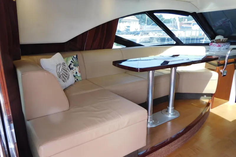 Slide: The Image of Luxurious interior of 2013 Sea Ray 510 Sundancer yacht with beige seating and wooden table. - 27
