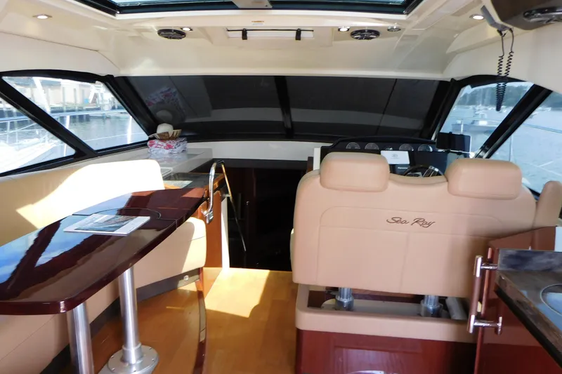 Slide: The Image of Interior of 2013 Sea Ray 510 Sundancer yacht with luxurious seating and helm. - 28