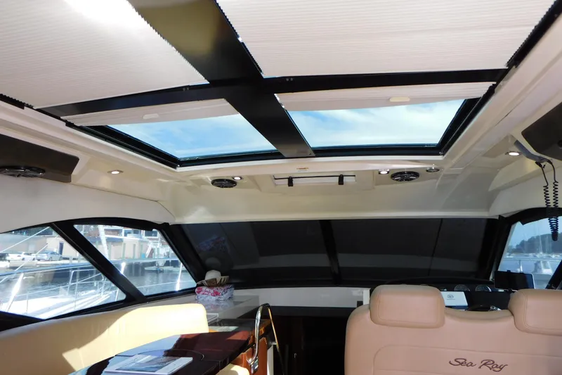 Slide: The Image of Interior view of 2013 Sea Ray 510 Sundancer yacht with sunroof and luxurious seating. - 29