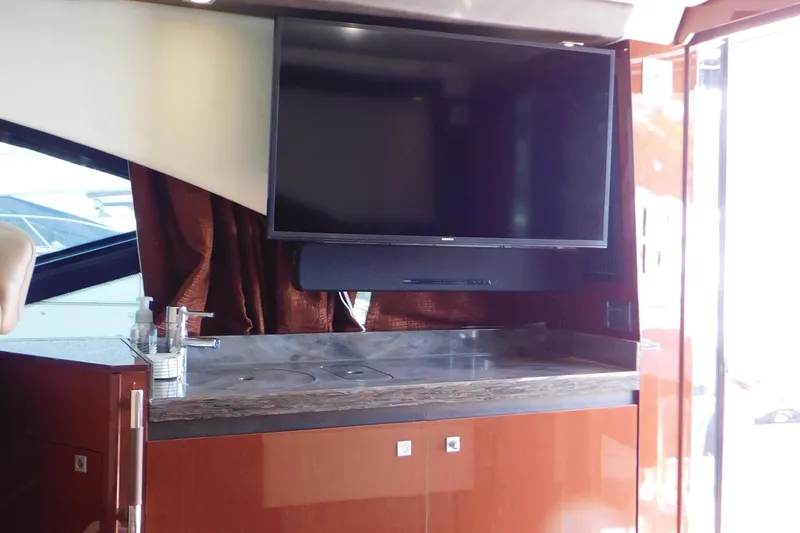 Slide: The Image of Luxurious interior of 2013 Sea Ray 510 Sundancer yacht with TV and kitchenette. - 30