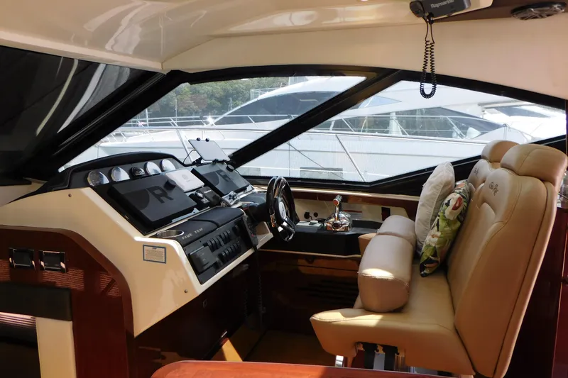 Slide: The Image of Interior cockpit of 2013 Sea Ray 510 Sundancer yacht with leather seating and modern controls. - 31