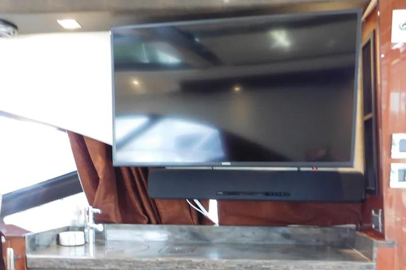 Slide: The Image of Flat-screen TV and soundbar in 2013 Sea Ray 510 Sundancer yacht interior. - 32
