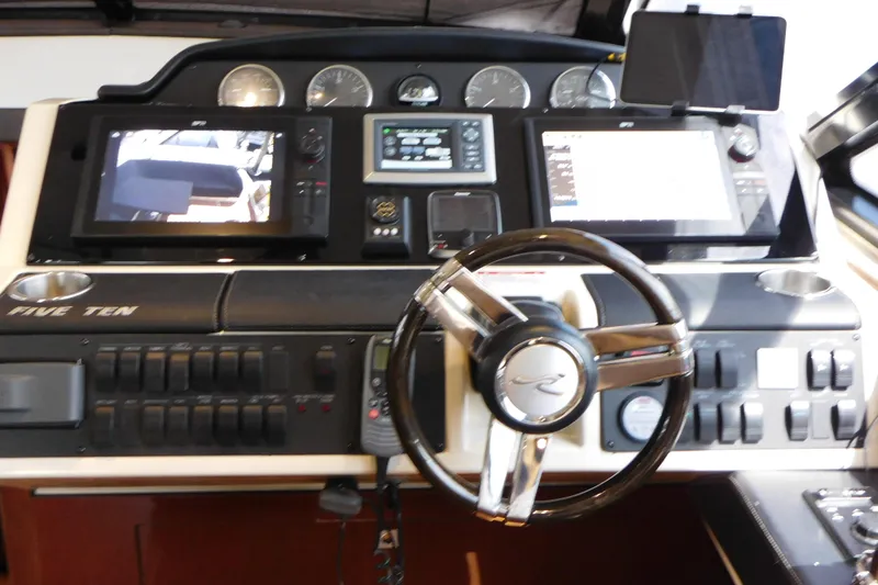 Slide: The Image of 2013 Sea Ray 510 Sundancer helm with advanced navigation displays and controls. - 44