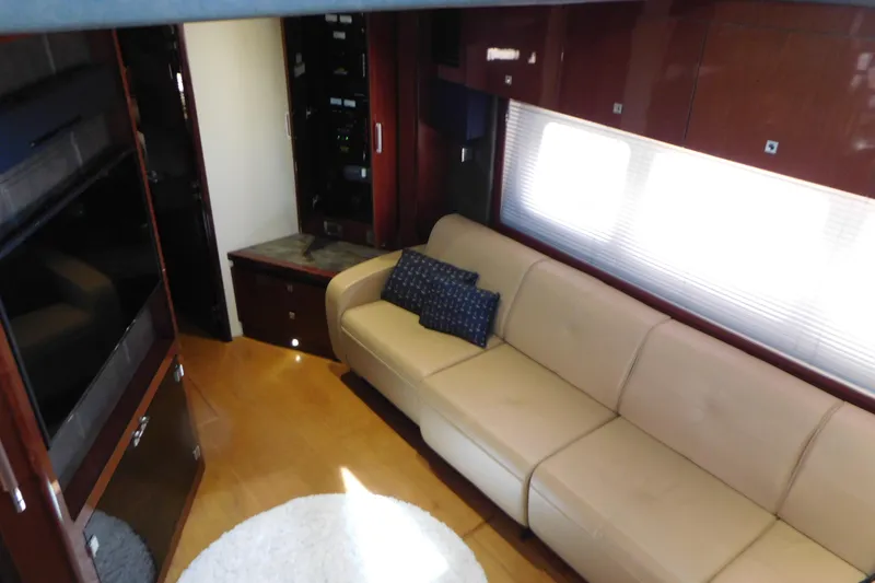 Slide: The Image of Luxurious interior of 2013 Sea Ray 510 Sundancer yacht with beige sofa and wooden cabinetry. - 46