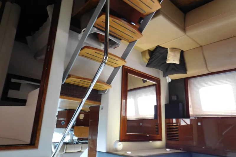 Slide: The Image of Interior of 2013 Sea Ray 510 Sundancer yacht with modern furnishings and wooden accents. - 49
