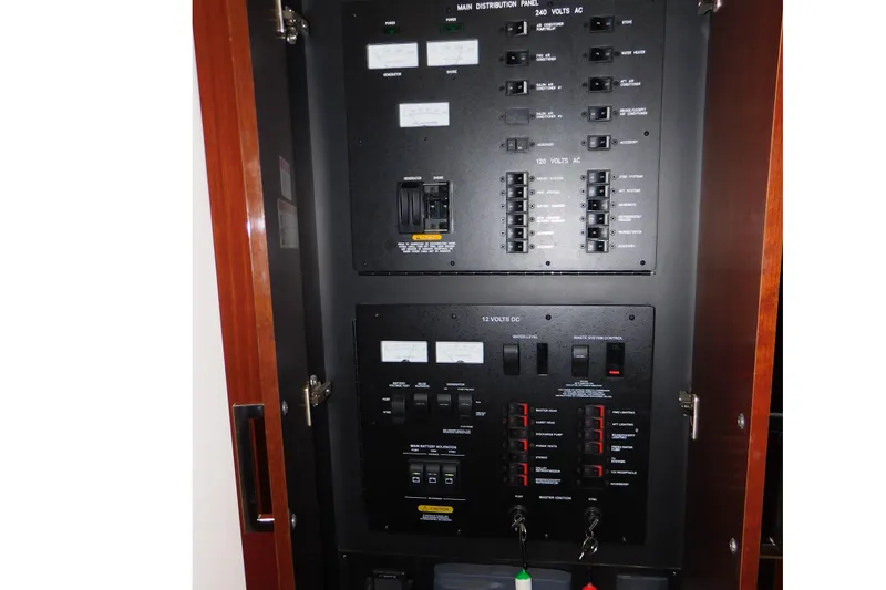 Slide: The Image of Electrical panel inside 2013 Sea Ray 510 Sundancer yacht, featuring various switches and controls. - 52