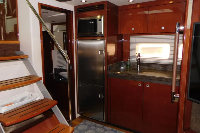 Slide: The Image of Luxurious 2013 Sea Ray 510 Sundancer yacht interior with modern kitchen and wooden stairs. - 58