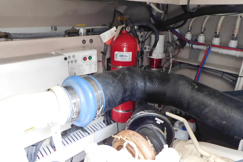 Slide: The Image of Engine room of 2013 Sea Ray 510 Sundancer with fire extinguisher and hoses. - 76