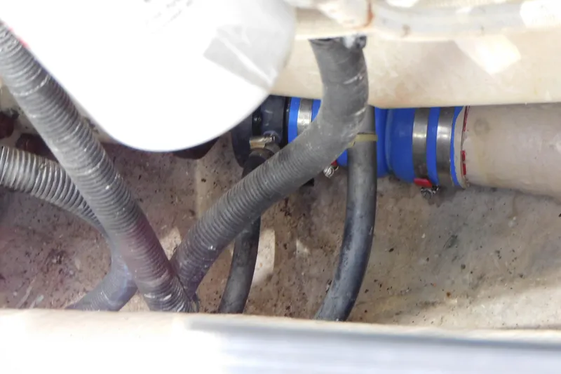 Slide: The Image of Engine compartment of 2013 Sea Ray 510 Sundancer with hoses and clamps visible. - 81