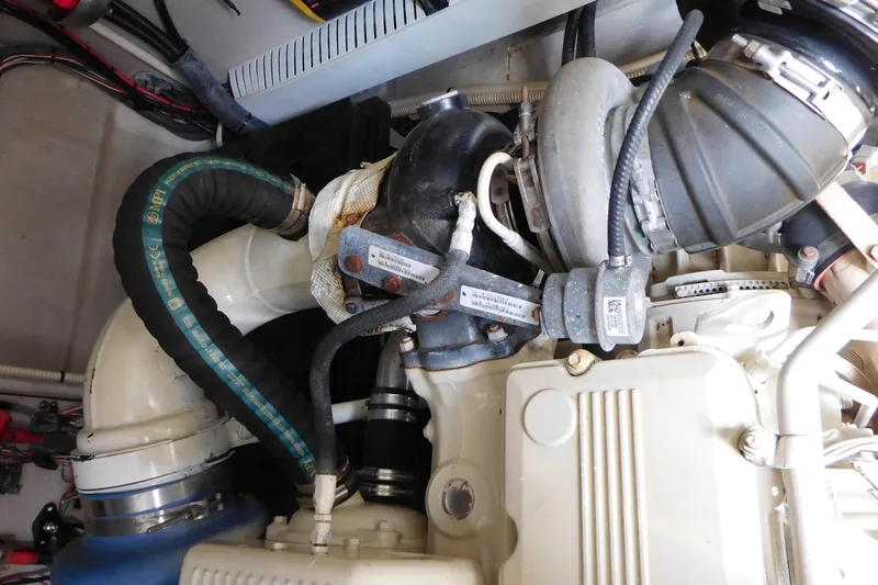 Slide: The Image of Engine compartment of a 2013 Sea Ray 510 Sundancer boat, showcasing mechanical components. - 84